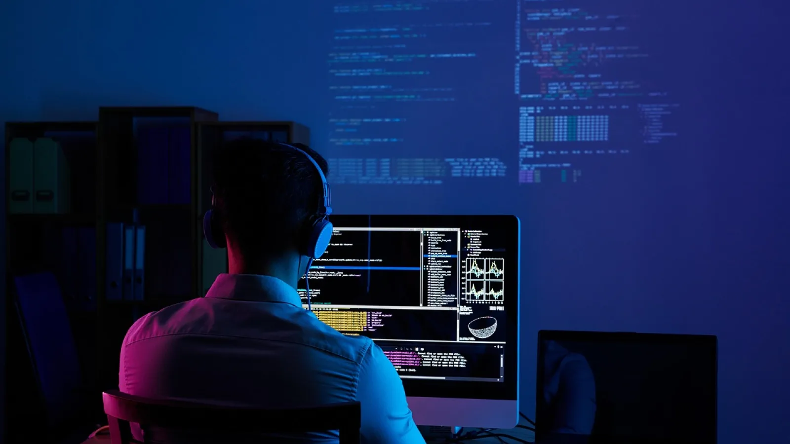 Developer using desktop dashboard tool to monitor AI coding assistant activity