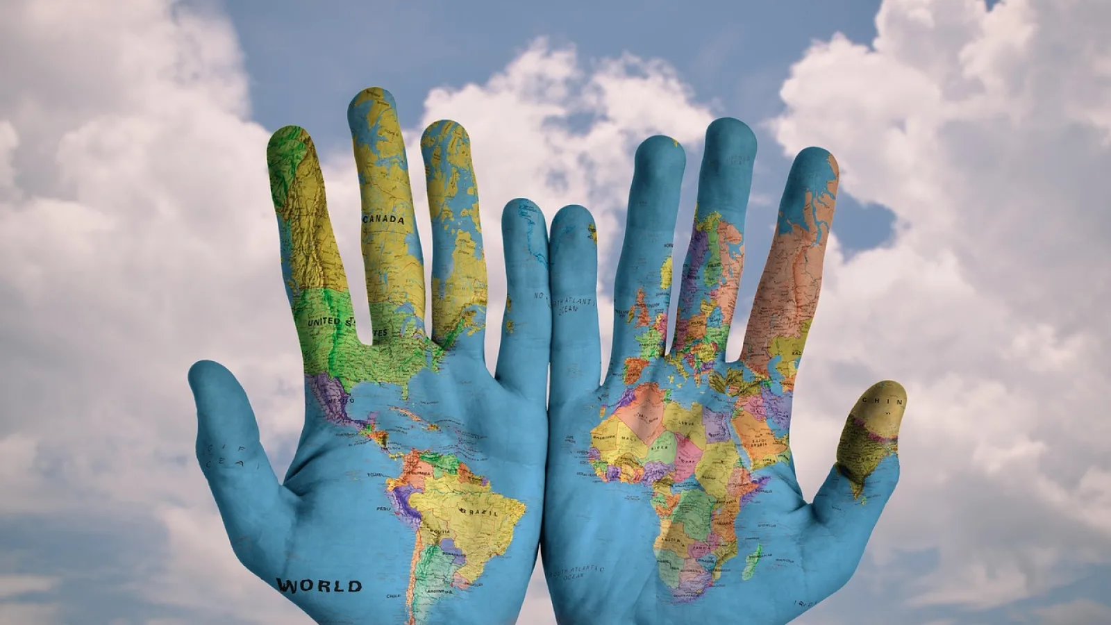 Hands with world map symbolicsing connections representing global order