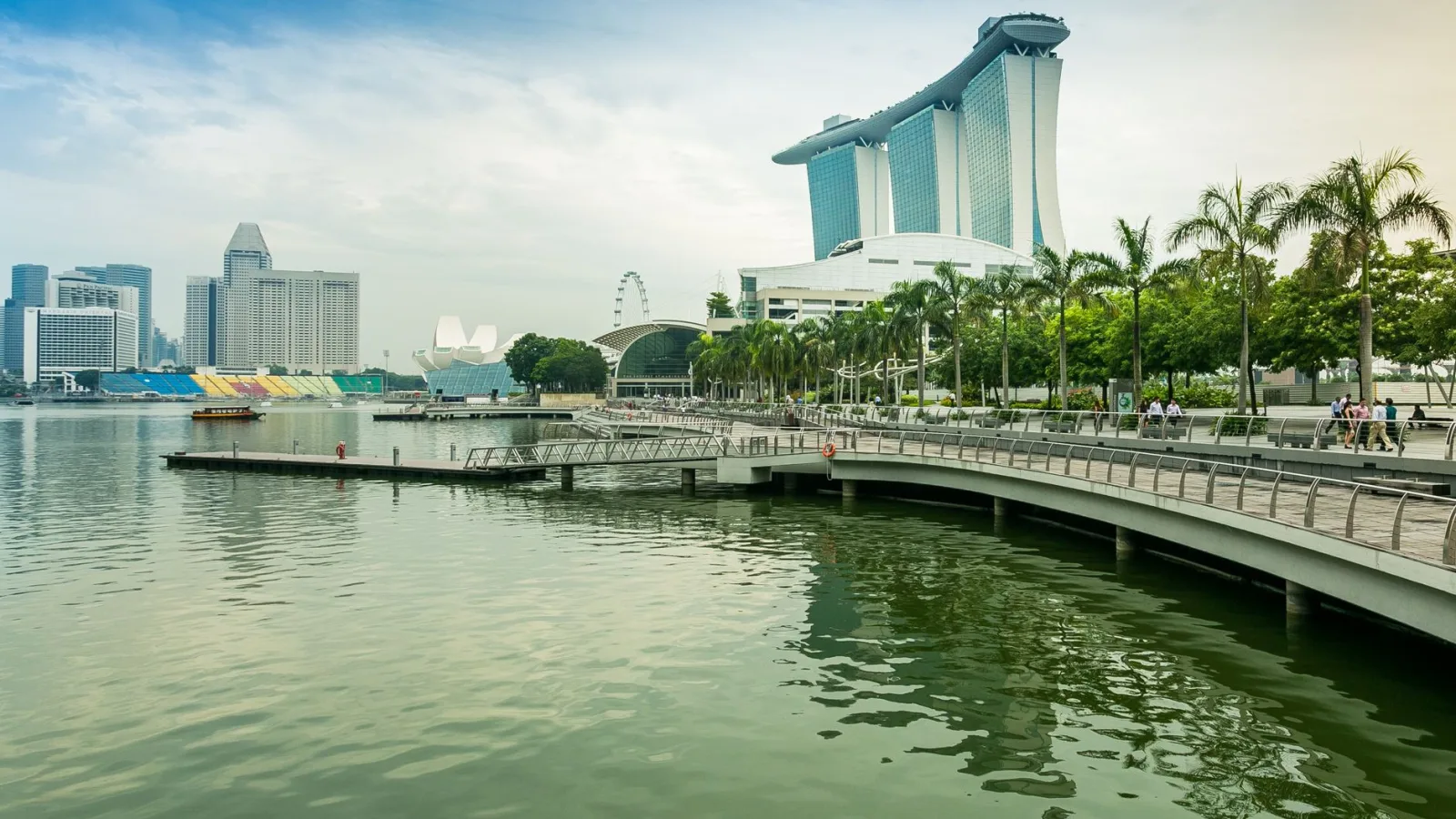 A stunning view of Marina Bay Sands and Singapore skyline with palm trees.