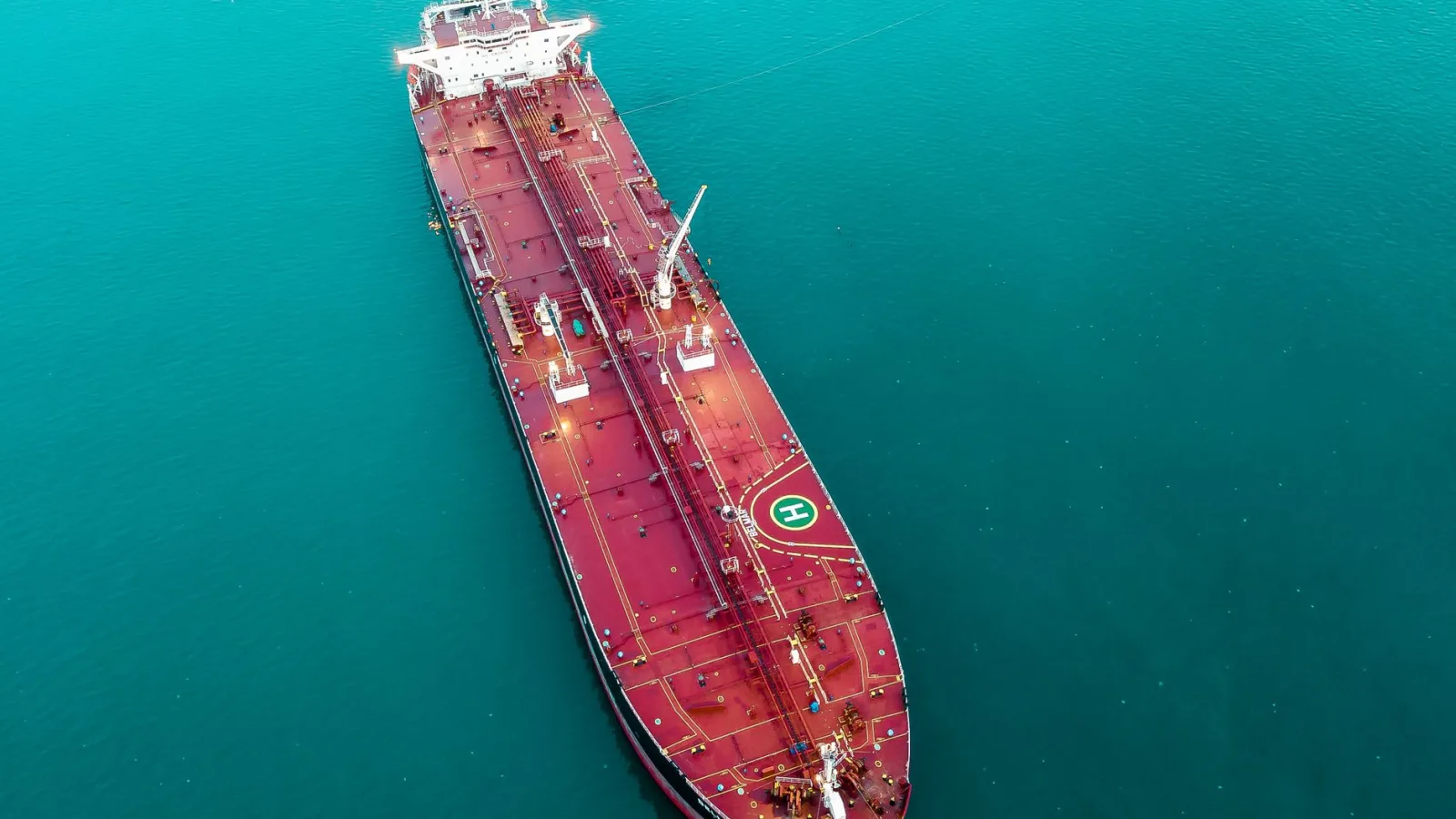 Aerial shot of an oil tanker cruising through the ocean, emphasizing maritime transport.